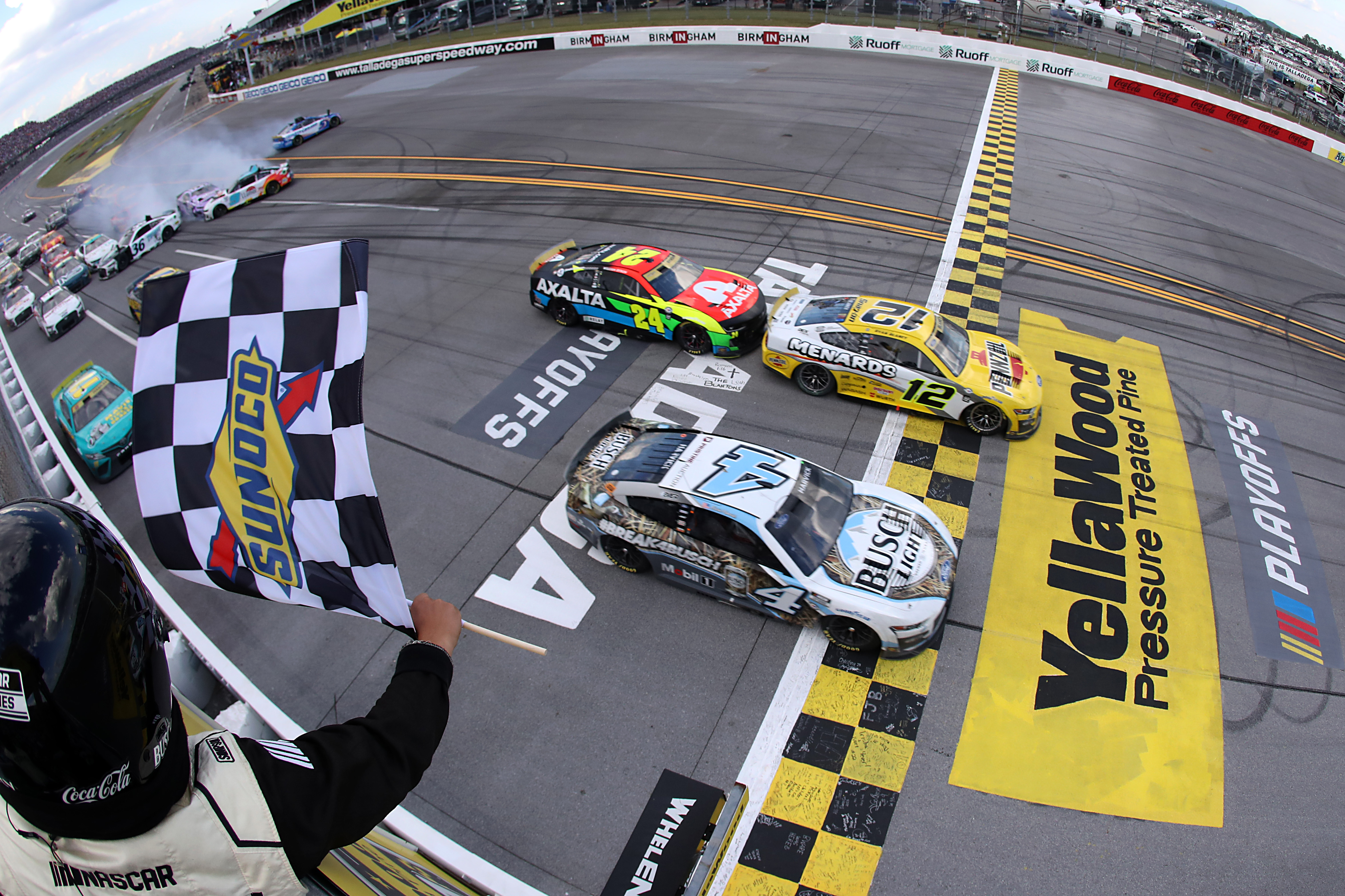 Ryan Blaney crosses the finish line ahead of Kevin Harvick to win Sunday's NASCAR Cup Series YellaWood 500 at Talladega Superspeedway, sending Blaney onto the Round of 8 in the playoffs. Meanwhile, Harvick's car was disqualified after post-race inspection. (Photo by Meg Oliphant/Getty Images)